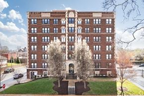 St. Louis apartment for rent - A large red brick building with a green lawn in front.