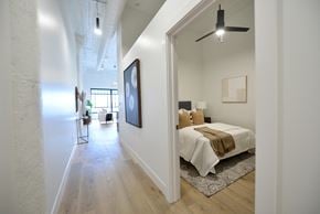 St. Louis apartment for rent - a bedroom with a bed and a hallway to a living room