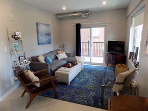St. Louis apartment for rent - A living room with a couch, chair, and television.