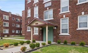 Kansas City apartment for rent - the front of a brick apartment building with a green door