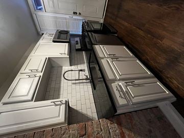 Kansas City apartment for rent - a kitchen with white cabinets and a wood floor
