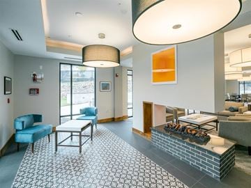 Kansas City apartment for rent - a living room with blue chairs and a fireplace