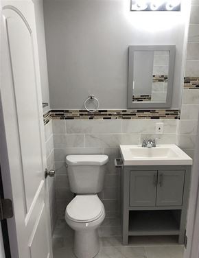 Kansas City apartment for rent - A white toilet sits next to a sink in a bathroom.