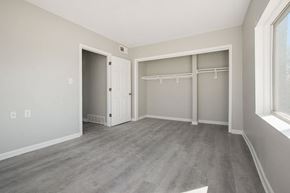 Kansas City apartment for rent - bedroom faux wood floor with a closet and a window