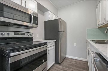 Kansas City apartment for rent - a kitchen with stainless steel appliances and a refrigerator