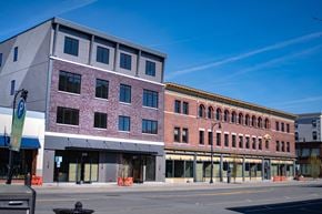 Pittsfield apartment for rent - A street view of a city with buildings and a clear blue sky.