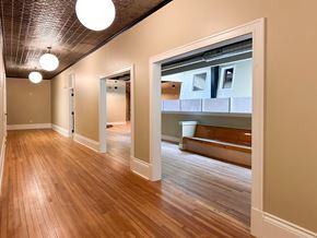 Pittsfield apartment for rent - A hallway with wood floors and a bench.