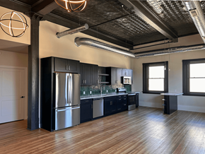 Pittsfield apartment for rent - A modern kitchen with a wooden floor and stainless steel appliances.