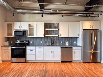 Pittsfield apartment for rent - A kitchen with white cabinets and stainless steel appliances.