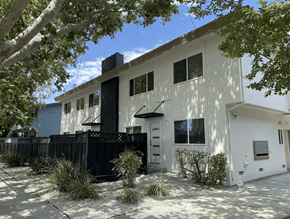 San Mateo apartment for rent - A white house with a black fence and trees in front.