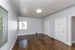 San Jose apartment for rent - a living room with white walls and a white door and a window