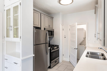 San Jose apartment for rent - a kitchen with stainless steel appliances and white cabinets