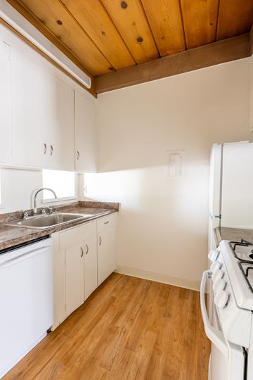 San Jose apartment for rent - a kitchen with white cabinets and a stove and a sink