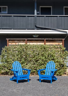 Mountain View apartment for rent - two blue chairs sitting in front of a building