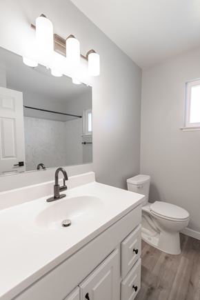 Mountain View apartment for rent - A white bathroom with a sink, toilet, and mirror.