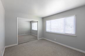 Mountain View apartment for rent - A room with a carpeted floor and a large mirror on the wall.