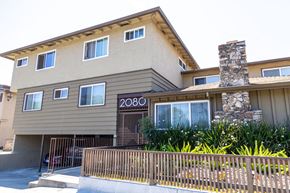 San Jose apartment for rent - the front of an apartment building with a fence