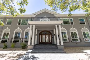 Redwood City apartment for rent - the front of a building with columns and a door