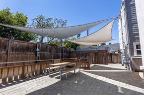 Redwood City apartment for rent - a patio with a picnic table and a hammock