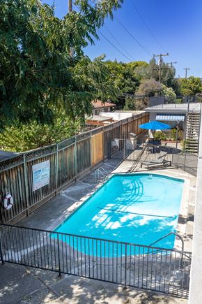 San Jose apartment for rent - a swimming pool in the backyard of a house with a fence around it
