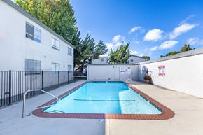 San Mateo apartment for rent - A small pool in a backyard surrounded by a black fence.