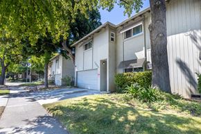 San Jose apartment for rent - a white house with a sidewalk and trees