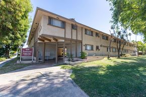San Jose apartment for rent - the front of a building with a sidewalk and grass