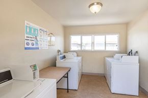 San Jose apartment for rent - a washer and dryer in a laundry room with two washing machines