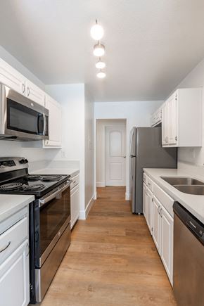Gilroy apartment for rent - a kitchen with stainless steel appliances and white cabinets