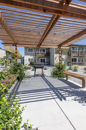 Gilroy apartment for rent - a covered patio with a picnic table and a grill