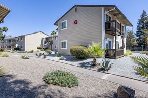 Gilroy apartment for rent - a house with a porch and a yard in front of it