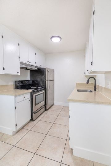 Gilroy apartment for rent - A kitchen with white cabinets and appliances.