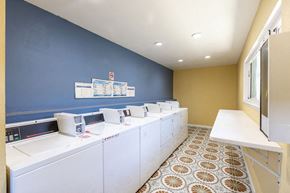 Gilroy apartment for rent - a laundry room with a row of washers and dryers