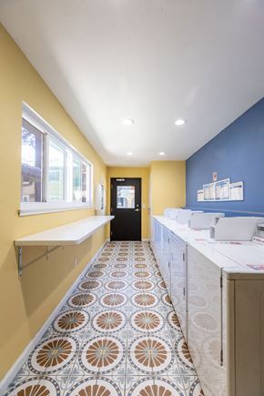 Gilroy apartment for rent - a laundry room with blue and yellow walls and a tile floor