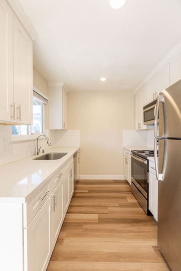 Santa Clara apartment for rent - A kitchen with white cabinets and stainless steel appliances.