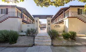 San Carlos apartment for rent - A sunny day at the entrance of a residential area with a staircase leading to a building.