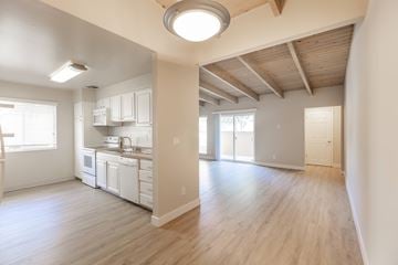 San Jose apartment for rent - A kitchen with white cabinets and a wooden ceiling.
