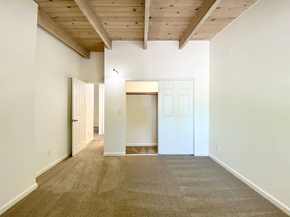 San Jose apartment for rent - A room with a carpeted floor and a wooden ceiling.