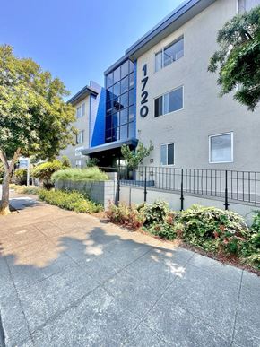 Oakland apartment for rent - Modern apartment building exterior with glass entry at The Chase Apartments Homes, Oakland, CA 94606