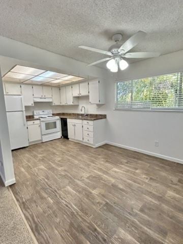 San Jose apartment for rent - A kitchen with white cabinets and a fan on the ceiling.