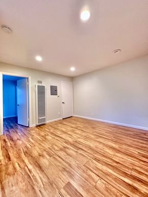 Redwood City apartment for rent - the living room of an empty house with wood flooring