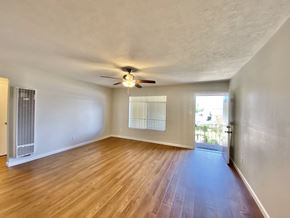 Sunnyvale apartment for rent - A room with a ceiling fan and wooden flooring.