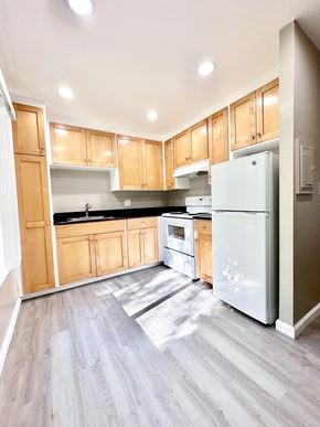 San Jose apartment for rent - an empty kitchen with wooden cabinets and stainless steel appliances