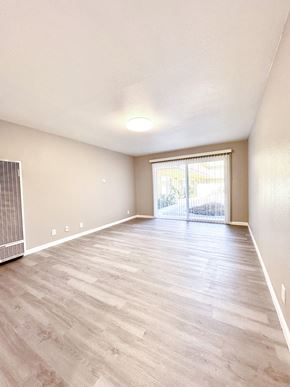 San Jose apartment for rent - an empty living room with hardwood flooring and a sliding glass door