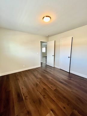 Santa Clara apartment for rent - A room with wooden floors and white walls.