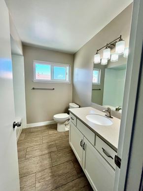 Santa Clara apartment for rent - A bathroom with a toilet, sink, and mirror.