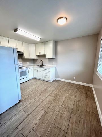 Santa Clara apartment for rent - A kitchen with a blue refrigerator and white cabinets.