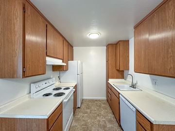 San Carlos apartment for rent - A kitchen with white appliances and wooden cabinets.
