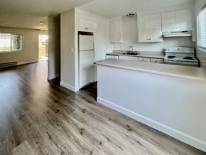 San Jose townhouse for rent - an empty kitchen with white cabinets and a white counter top