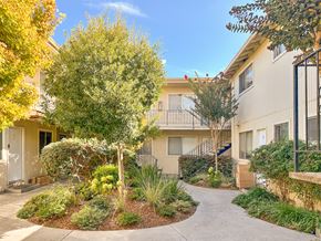San Jose apartment for rent - A sunny day at a residential area with apartment buildings and a well-maintained garden.